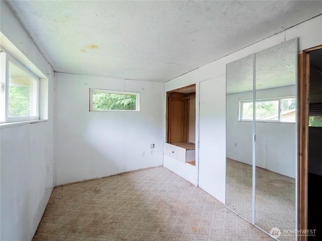 9712 Channel Dr NW, Olympia, WA 98502 - unfurnished bedroom featuring multiple windows and carpet floors