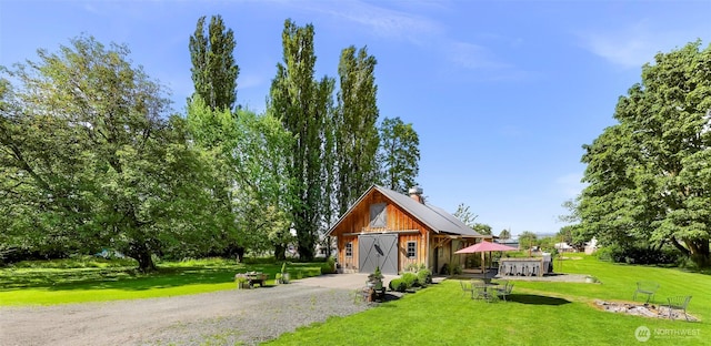 329 Columbia St, Sumas, WA 98295 - view of front of property with a front lawn, an outbuilding, and a chimney