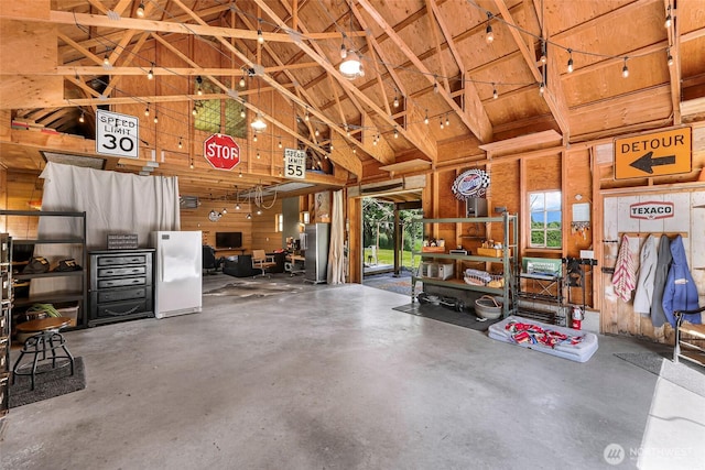 329 Columbia St, Sumas, WA 98295 - garage with wood ceiling, freestanding refrigerator, and wood walls