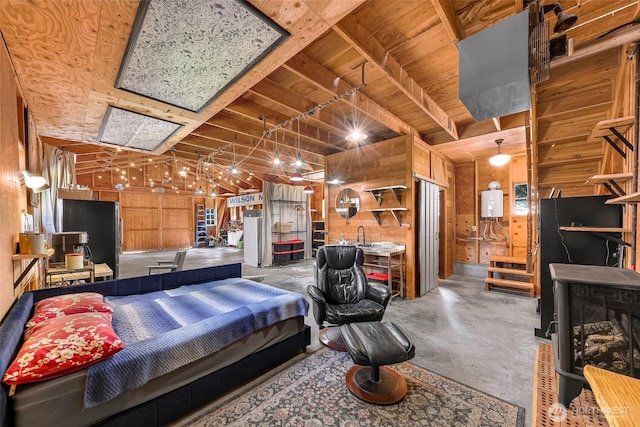 329 Columbia St, Sumas, WA 98295 - bedroom featuring wooden walls, finished concrete floors, wooden ceiling, and tankless water heater