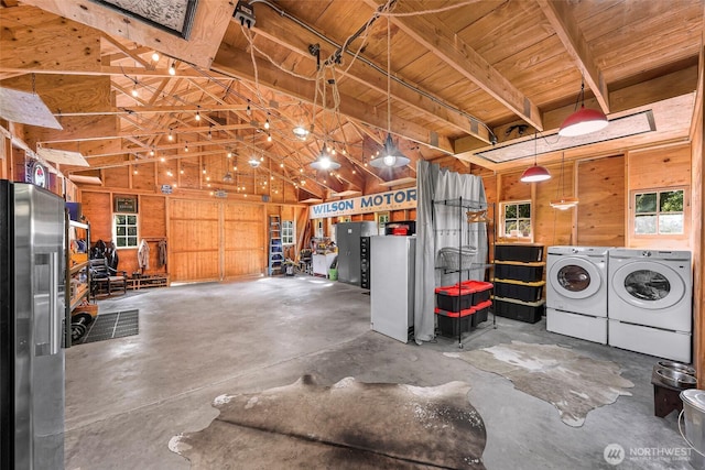 329 Columbia St, Sumas, WA 98295 - garage with washing machine and clothes dryer, stainless steel fridge, wooden ceiling, and wood walls