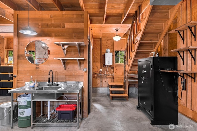 329 Columbia St, Sumas, WA 98295 - misc room featuring wooden walls, concrete floors, and water heater