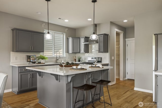 26216 SE 228th Ave SE Unit 26216, Maple Valley, WA 98038 - kitchen with stove, light countertops, gray cabinets, tasteful backsplash, and recessed lighting