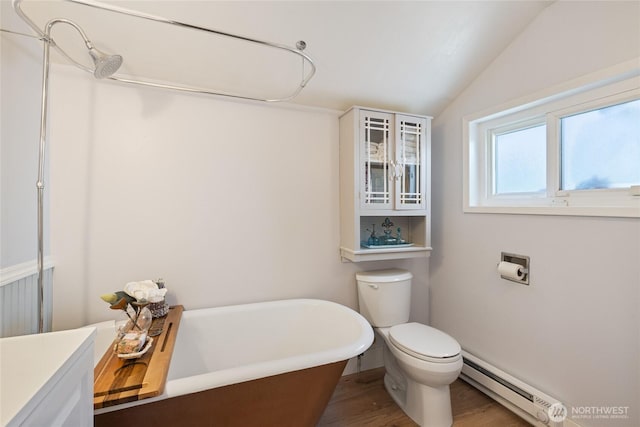 1007 N Ferdinand St, Tacoma, WA 98406 - bathroom featuring baseboard heating, a soaking tub, vaulted ceiling, wood finished floors, and toilet