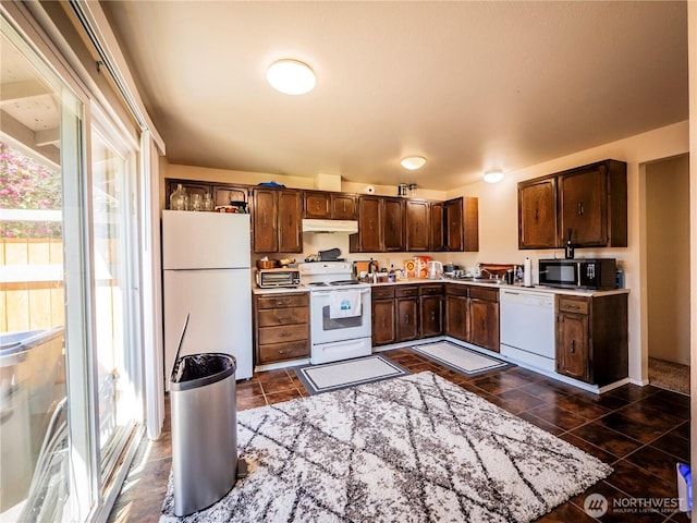919 Harding Rd, Elma, WA 98541 - kitchen with white appliances, under cabinet range hood, light countertops, dark brown cabinetry, and dark tile patterned floors