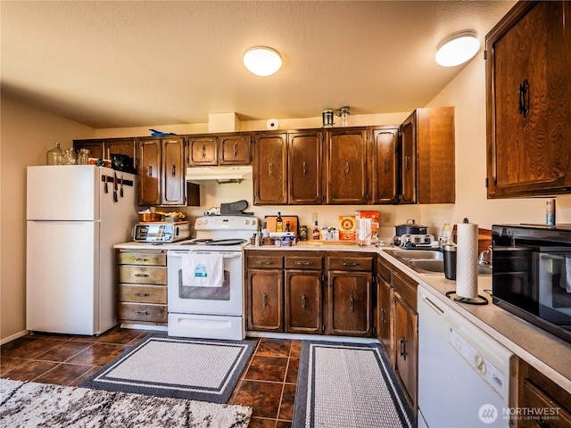 919 Harding Rd, Elma, WA 98541 - kitchen featuring white appliances, under cabinet range hood, light countertops, dark tile patterned floors, and dark brown cabinets