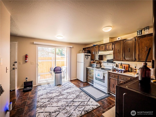 919 Harding Rd, Elma, WA 98541 - kitchen featuring white appliances, under cabinet range hood, dark brown cabinets, a textured ceiling, and light countertops