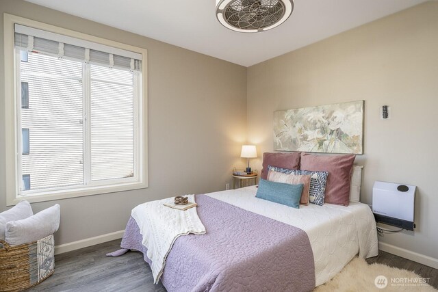 124 Bellevue Ave E Unit 305, Seattle, WA 98102 - bedroom with baseboards, wood finished floors, and heating unit