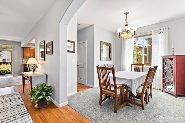 8521 15th Ave SE, Olympia, WA 98513 - dining area with a chandelier, arched walkways, and light wood-style floors