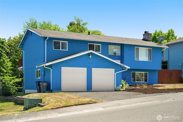 33046 38th Ave SW, Federal Way, WA 98023 - view of front of property with an attached garage, a chimney, and asphalt driveway