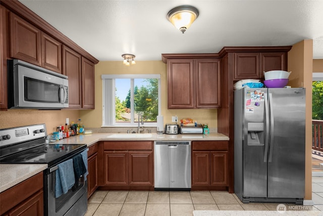 33046 38th Ave SW, Federal Way, WA 98023 - kitchen with appliances with stainless steel finishes, light tile patterned floors, and light countertops