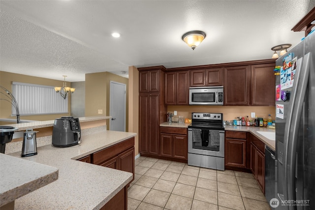 33046 38th Ave SW, Federal Way, WA 98023 - kitchen featuring stainless steel appliances, light countertops, a chandelier, light tile patterned floors, and recessed lighting