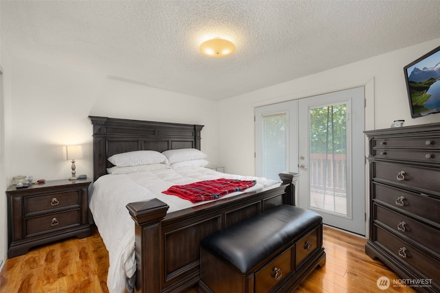 33046 38th Ave SW, Federal Way, WA 98023 - bedroom with access to exterior, a textured ceiling, and light wood-type flooring