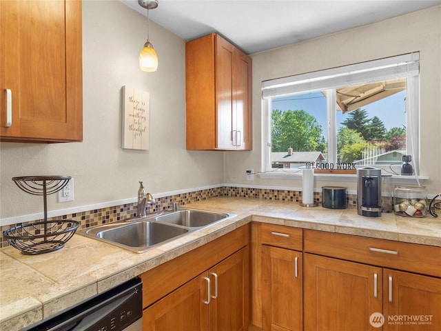 8828 S K St, Tacoma, WA 98444 - kitchen featuring dishwasher, a sink, brown cabinetry, pendant lighting, and tile countertops