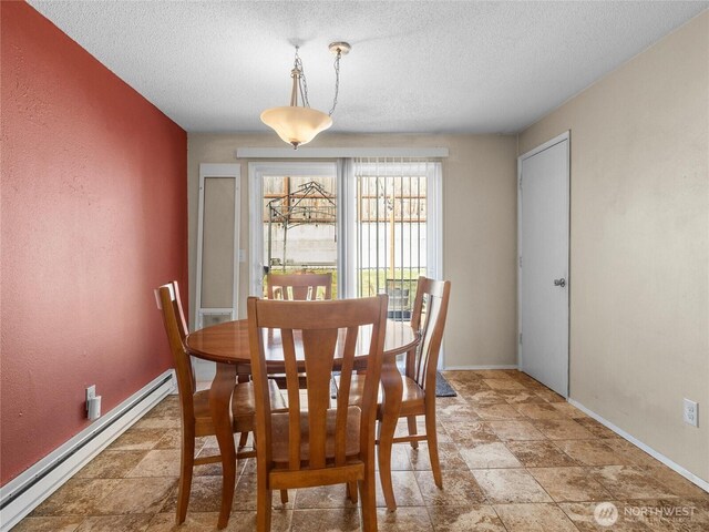 8828 S K St, Tacoma, WA 98444 - dining area with baseboard heating, a textured ceiling, baseboards, and light stone finish flooring
