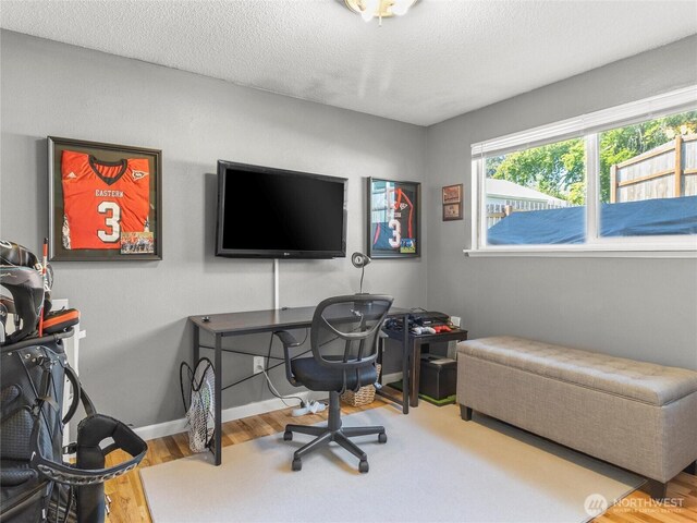 8828 S K St, Tacoma, WA 98444 - home office featuring wood finished floors, baseboards, and a textured ceiling