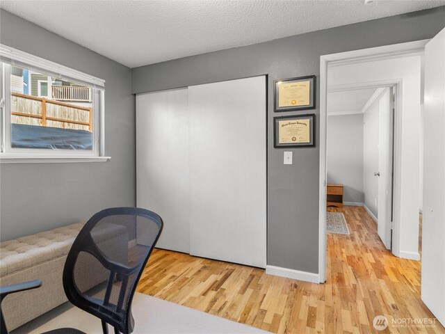 8828 S K St, Tacoma, WA 98444 - unfurnished office with light wood-style floors, baseboards, and a textured ceiling