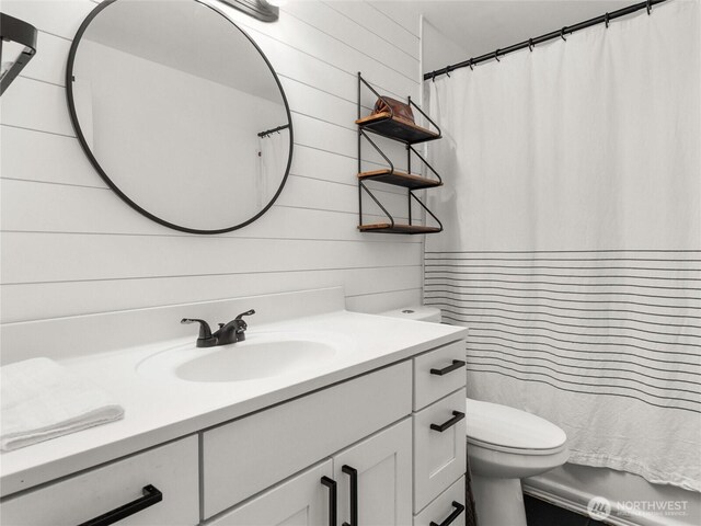 8828 S K St, Tacoma, WA 98444 - full bath with toilet, vanity, wooden walls, and a shower with shower curtain