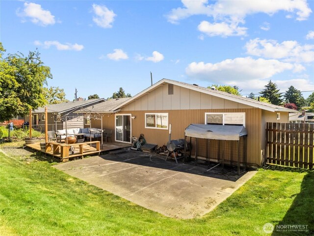 8828 S K St, Tacoma, WA 98444 - back of property with a deck, an outdoor hot tub, outdoor lounge area, and a patio