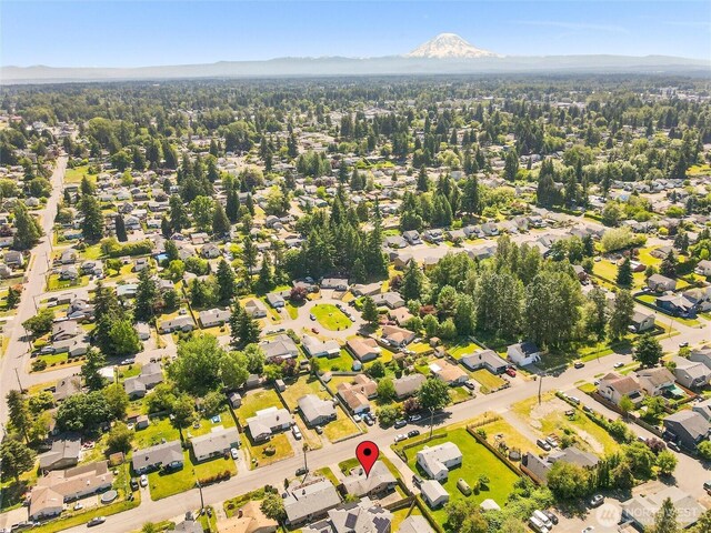 8828 S K St, Tacoma, WA 98444 - aerial view of property and surrounding area featuring mountains and nearby suburban area
