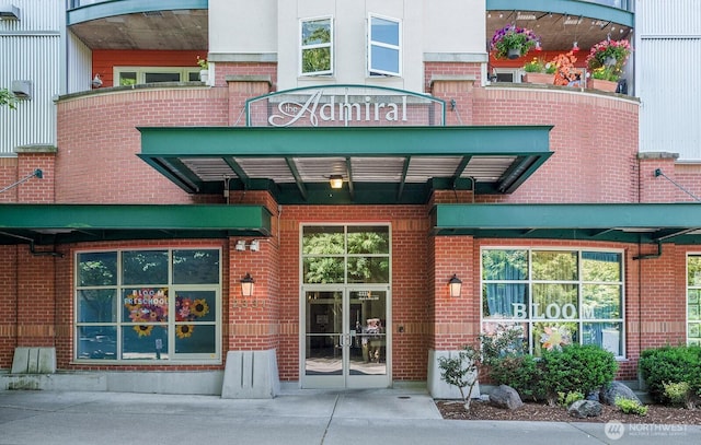 2331 42nd Ave SW Unit 206, Seattle, WA 98116 - view of exterior entry featuring brick siding and french doors