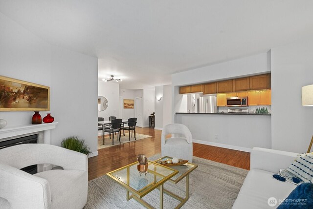 2331 42nd Ave SW Unit 206, Seattle, WA 98116 - living area with wood finished floors and a fireplace