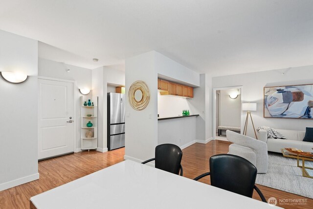 2331 42nd Ave SW Unit 206, Seattle, WA 98116 - dining room with light wood-type flooring, baseboards, and an office area