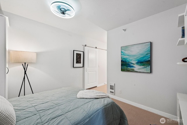 2331 42nd Ave SW Unit 206, Seattle, WA 98116 - bedroom featuring carpet floors, baseboards, and a barn door