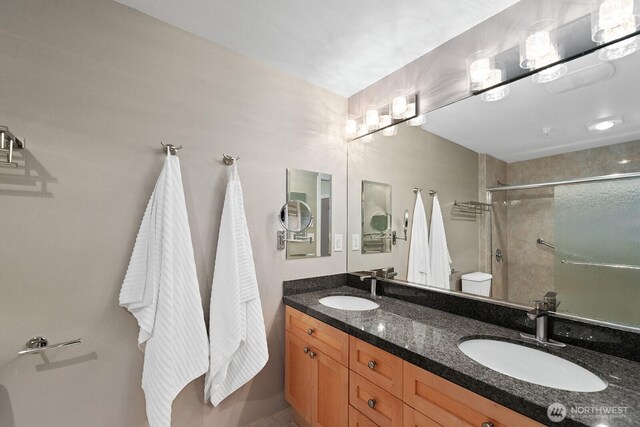 2331 42nd Ave SW Unit 206, Seattle, WA 98116 - full bathroom with toilet, a shower with shower door, and double vanity