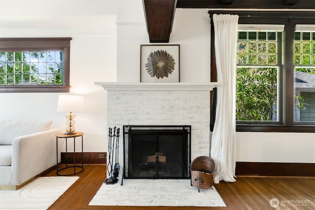 106 W Mcgraw St, Seattle, WA 98119 - detailed view of wood finished floors, a brick fireplace, and baseboards