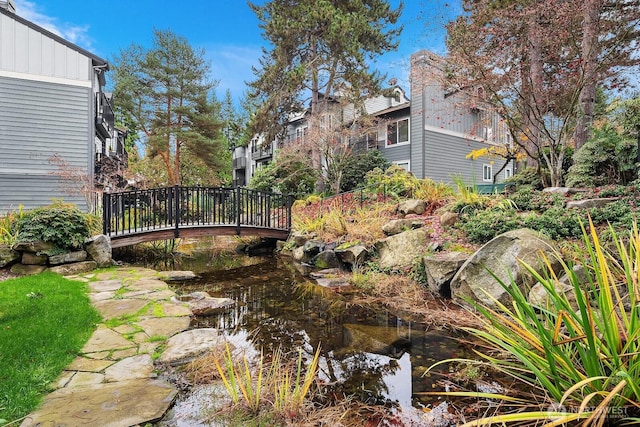 11113 NE 125th Ln Unit E-319, Kirkland, WA 98034 - view of yard with a garden pond and a deck