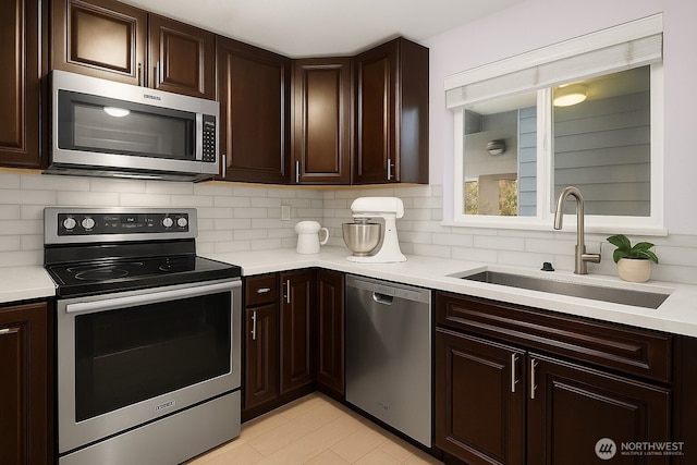 11113 NE 125th Ln Unit E-319, Kirkland, WA 98034 - kitchen featuring stainless steel appliances, a sink, light countertops, and tasteful backsplash
