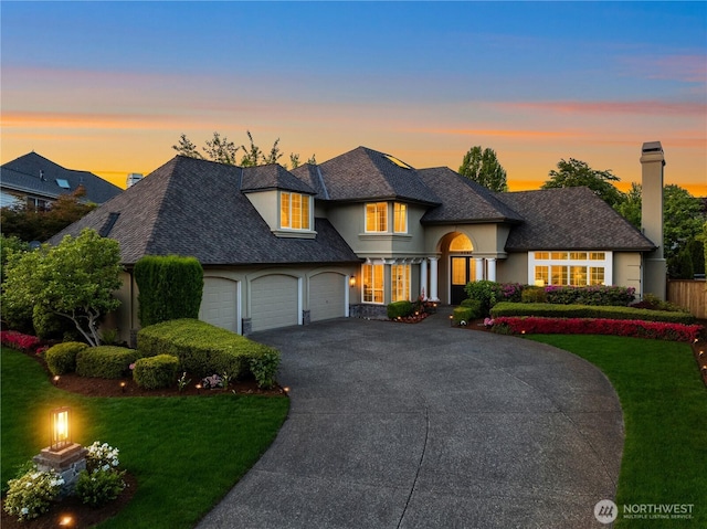 2260 269th Ct SE, Sammamish, WA 98075 - french country inspired facade with driveway, a lawn, an attached garage, and stucco siding