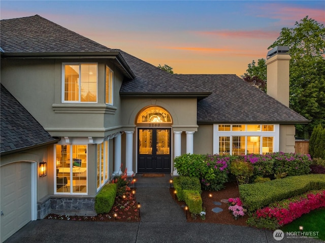2260 269th Ct SE, Sammamish, WA 98075 - view of front of property with a shingled roof, a chimney, stucco siding, and an attached garage