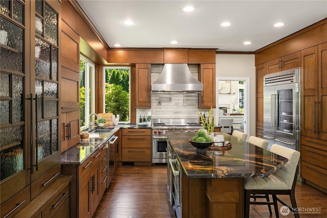 2260 269th Ct SE, Sammamish, WA 98075 - kitchen featuring wall chimney range hood, high quality appliances, a sink, crown molding, and tasteful backsplash