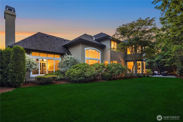 2260 269th Ct SE, Sammamish, WA 98075 - view of front of home featuring a lawn, a shingled roof, a chimney, and a patio area