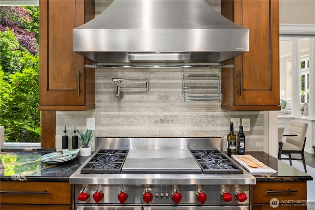 2260 269th Ct SE, Sammamish, WA 98075 - kitchen featuring wall chimney range hood, stainless steel stove, backsplash, and brown cabinetry