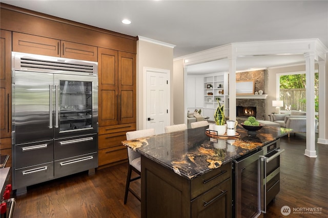 2260 269th Ct SE, Sammamish, WA 98075 - kitchen featuring stainless steel built in refrigerator, wine cooler, dark wood finished floors, a kitchen breakfast bar, and crown molding