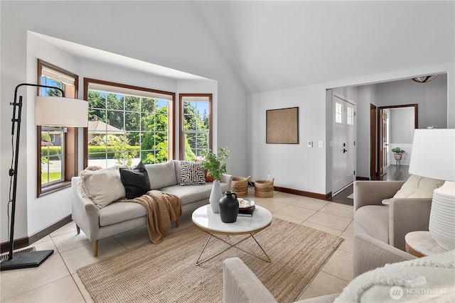 18620 29th Ave SE, Bothell, WA 98012 - living room featuring light tile patterned flooring, healthy amount of natural light, high vaulted ceiling, and baseboards