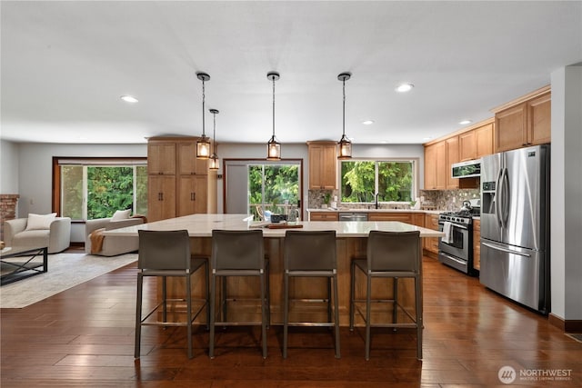 18620 29th Ave SE, Bothell, WA 98012 - kitchen featuring appliances with stainless steel finishes, range hood, light countertops, open floor plan, and dark wood finished floors
