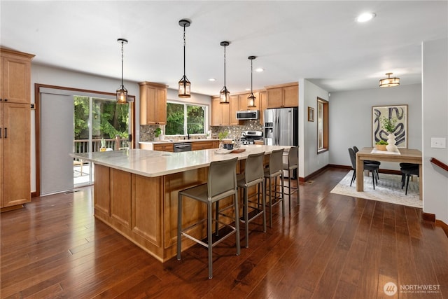 18620 29th Ave SE, Bothell, WA 98012 - kitchen featuring appliances with stainless steel finishes, decorative backsplash, light countertops, dark wood-style floors, and recessed lighting