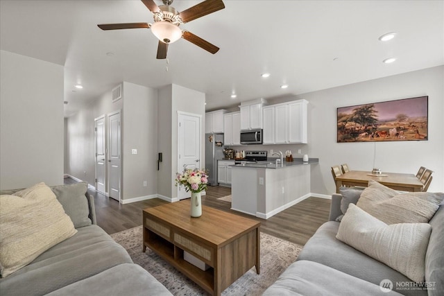 8603 E Gilman Ave, Arlington, WA 98223 - living area featuring dark wood-style flooring, baseboards, a ceiling fan, and recessed lighting