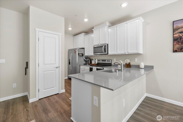 8603 E Gilman Ave, Arlington, WA 98223 - kitchen with appliances with stainless steel finishes, a sink, white cabinetry, baseboards, and recessed lighting