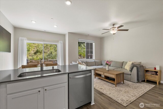 8603 E Gilman Ave, Arlington, WA 98223 - kitchen with stainless steel dishwasher, a sink, a ceiling fan, dark countertops, and white cabinets