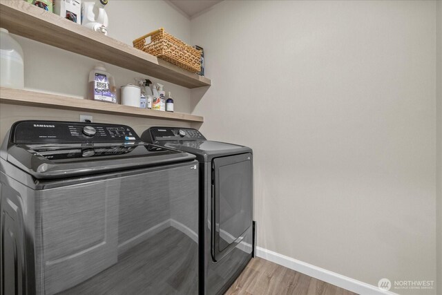 8603 E Gilman Ave, Arlington, WA 98223 - washroom with light wood-style flooring, washing machine and clothes dryer, and baseboards