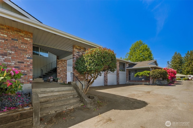 17464 Dunbar Rd Unit 1, Mount Vernon, WA 98273 - view of front facade with brick siding, driveway, board and batten siding, and a garage
