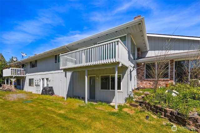 17464 Dunbar Rd Unit 1, Mount Vernon, WA 98273 - rear view of house featuring a chimney, a lawn, a deck, and brick siding