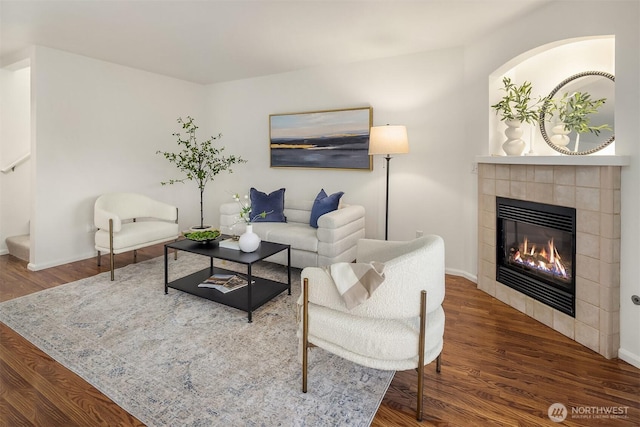 901 E Marine View Dr Unit 106, Everett, WA 98201 - living area with a tiled fireplace, wood finished floors, stairs, and baseboards
