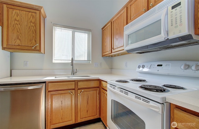 712 SE 5th Way, Battle Ground, WA 98604 - kitchen featuring white appliances, a sink, light countertops, and brown cabinetry