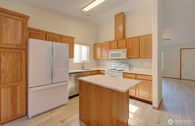 712 SE 5th Way, Battle Ground, WA 98604 - kitchen with white appliances, a sink, light wood finished floors, light countertops, and high vaulted ceiling
